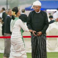 National League for Democracy leader Aung San Suu Kyi (left) is welcomed by new Myanmar President Htin Kyaw during a dinner reception in Naypyitaw on Wednesday. | AP