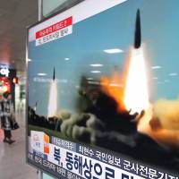 A TV screen shows a file footage of a missile launch conducted by North Korea, at Seoul Railway Station in Seoul, on Thursday. | AP