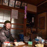 Yasukatsu Miura tells of living in his tsunami-ravaged house in Ishinomaki, Miyagi Prefecture, on Feb. 13. | SATOKO KAWASAKI