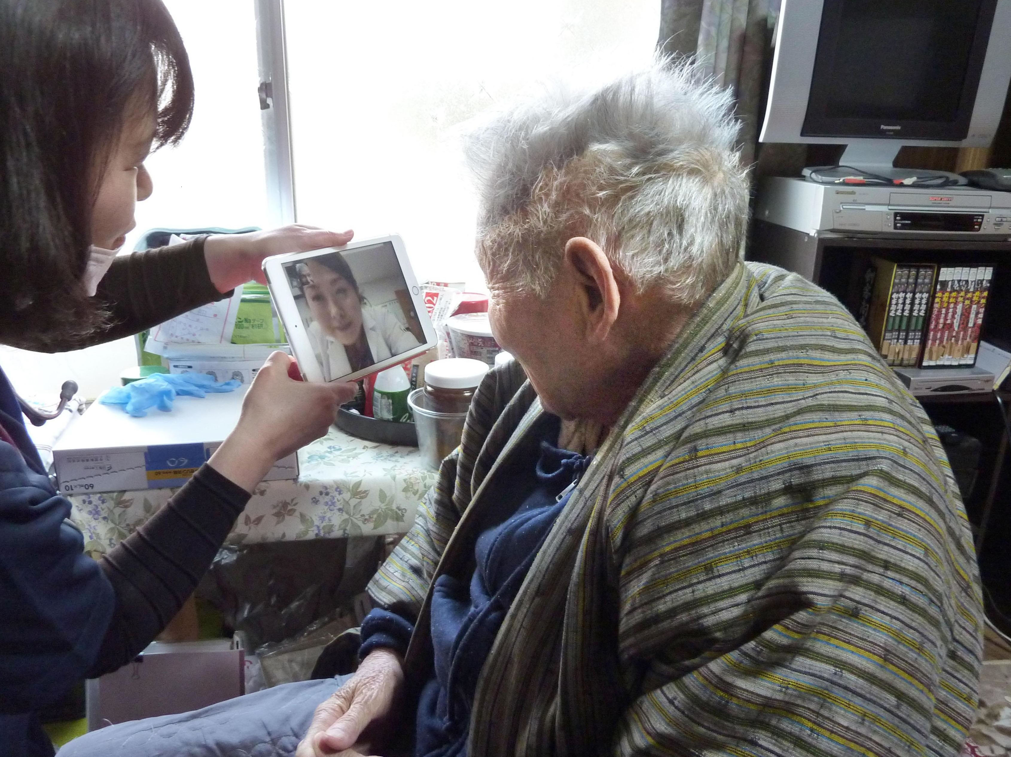 Patient Akira Fujisawa talks with his doctor via video link using a tablet computer at his home in Takamatsu, Kagawa Prefecture, on March 1. | KYODO