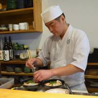 Seafood stack: Chef Futoshi Fujimoto puts the final touches on his version of the kaisendon, a generous serving of fresh sashimi on a bed of rice. | J.J. O\'DONOGHUE
