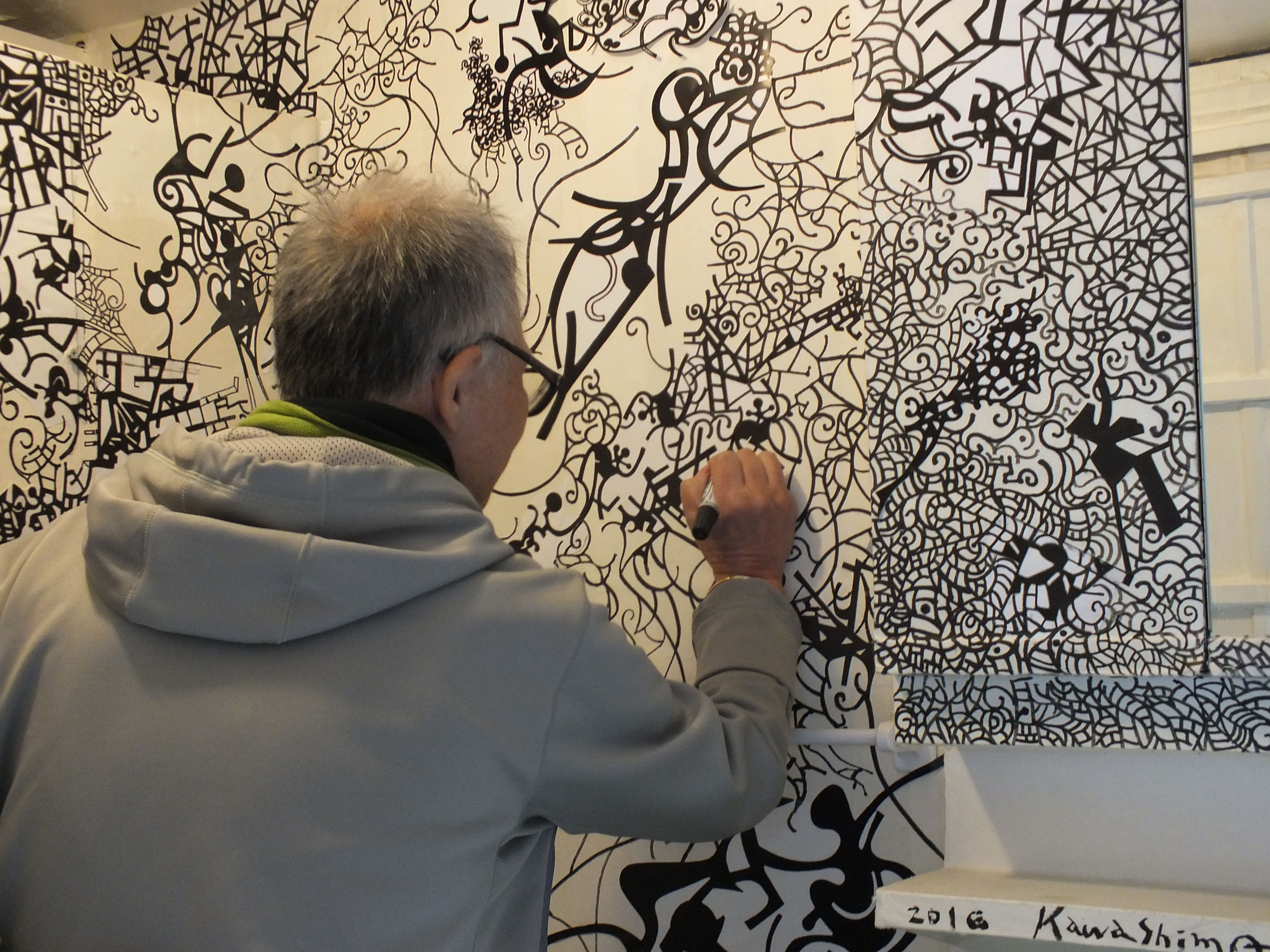 Born again: Artist Takeshi Kawashima puts the finishing touches to his work 'Kaleidoscope Black and White' on Ogijima Island. Until recently facing a shrinking, aging population, Ogijima is growing thanks to its thriving community-based art scene. | DAVID BILLA