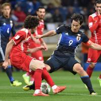 Shinji Okazaki (9) controls the ball during Japan’s 5-0 win over Syria at Saitama Stadium on Tuesday. Centurion Okazaki looking for balance after win over Syria