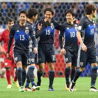 Japan\'s Mu Kanazaki (15) is congratulated by teammates after scoring a 78th-minute goal against Afghanistan on Thursday. | AFP-JIJI