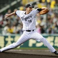Hanshin\'s Kyuji Fujikawa delivers during the Tigers\' 4-0 preseason win over the Fighters at Koshien Stadium on Sunday. | KYODO