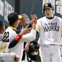The Hawks\' Yuki Yanagita (right) fired up his teammates on Friday, when he slugged two home runs in a game against the Tigers that ended in a 3-3 tie in Fukuoka. | KYODO