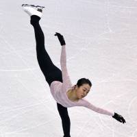 Mao Asada, seen here practicing a spiral on Monday, will attempt to win her fourth world title this week in Boston. | AP