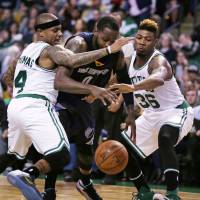 Celtics guards Isaiah Thomas (left) and Marcus Smart, seen defending the Grizzlies’ JaMychal Green during a recent game, exemplify the team’s scrappy style of play. Celtics seeking missing piece to become legitimate title contenders