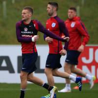 England’s Jamie Vardy (left) warms up with Gary Cahill and Ross Barkley during a training session at St. George’s Park in Burton, England, Tuesday . England faces Germany on Saturday in Berlin. Friendly with Germany provides first test for England