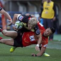 The Sunwolves\' Akihito Yamada (right) tackles Jaco van der Walt of the Lions during the Sunwolves\' Super Rugby debut at Prince Chichibu Memorial Ground last Saturday. | REUTERS