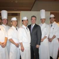 Christopher Clark (fourth from right), general manager of The Ritz-Carlton Osaka, poses with chefs from the Hanagatami restaurant at a press party on March 3, the day before the Japanese restaurant reopened. | HIROKO INOUE