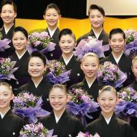 Takarazuka Music School graduates, who will join the all-women Takarazuka theater troupe, pose for commemorative photos after their graduation ceremony in Takarazuka, Hyogo Prefecture, on Tuesday. The 36 graduates will appear in \"The Entertainer!\" when it opens March 18. | KYODO