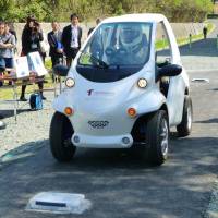 Toyohashi University of Technology and Taisei Corp. unveil a battery-less car that draws power from an electrified road surface in Toyohashi, Aichi Prefecture, on Friday. | KYODO
