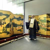 A digital facsimile of \"Genji Monogatari-zu Byobu,\" a renowned folding screen depicting scenes from \"The Tale of Genji,\" is displayed at Byodoin Temple in Uji, Kyoto Prefecture, on Friday. The facsimile was created using Canon Inc.\'s cutting-edge imaging technology. The original, by artist Mitsuyoshi Tosa, is owned by the Metropolitan Museum of Art in New York. | KYODO