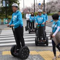 Nobuto Hosaka, the mayor of Tokyo’s Setagaya Ward, tries out a Segway in the Futako-Tamagawa area Tuesday. | SATOKO KAWASAKI