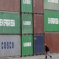 Cargo containers are seen stacked in Tokyo in February. Japan\'s trade deficit in fiscal 2015 was &#165;1.08 trillion. | AP