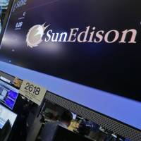 The SunEdison post is seen on the floor of the New York Stock Exchange on March 8. | AP