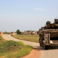 Syrian government forces\' tanks patrol the town of Khan Tuman, south of the northern city of Aleppo on Monday following clashes in the area with opposition fighters the previous night. | AFP-JIJI