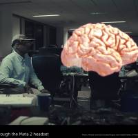 This image from footage taken through a Meta 2 headset shows a model of a brain superimposed over an otherwise unimpeded view — in this case, Meta’s offices in Redwood City, California, with another employee using a headset. AR entrepreneurs mapping out mind-bending trip