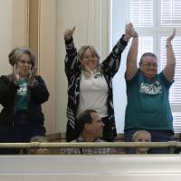 Supporters of a bill to raise California\'s minimum wage celebrate in the state Senate gallery after the measure was approved by the Senate on Thursday. | AP