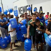Residents stand in line as they wait to buy potable water in Manta, Ecuador, Monday. The strongest earthquake to hit Ecuador in decades flattened buildings and buckled highways along its Pacific coast, sending the Andean nation into a state of emergency. | AP