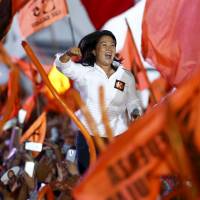 Keiko Fujimori waves to supporters during her closing presidential campaign rally in Lima on Thursday. | REUTERS