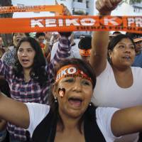 Peru presidential candidate Keiko Fujimori\'s supporters celebrate after the exit polls of the first round of Peru\'s presidential election in Lima on Sunday. | PACO CHUQUIURE / REUTERS
