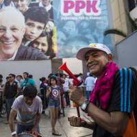 Supporters of the presidential candidate Pedro Pablo Kuczynski of the Peruanos por el Kambio party celebrate in Lima on Sunday during the general election. Keiko Fujimori, daughter of an ex-president jailed for massacres, topped the first-round vote Sunday in troubled elections that will make her Peru\'s first female leader if she wins a runoff. | AFP-JIJI