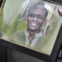 A man holds a portrait of professor Rezaul Karim Siddique, who was hacked to death by unidentified attackers, in Rajshahi, Bangladesh, on Saturday. University professor hacked to death in Bangladesh; Islamic State group claimed responsibility