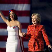 Democratic presidential candidate Hillary Clinton arrives with singer Katy Perry during a campaign rally in Des Moines, Iowa, in October. | REUTERS