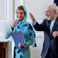Iranian Foreign Minister Mohammad Javad Zarif (right) and European Union foreign policy chief Federica Mogherini chat at the end of their news conference in Tehran on Saturday. | AP