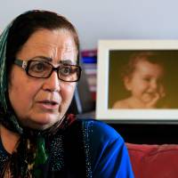 Lebanese Ibtissam Berri speaks during an April 7 interview with The Associated Press as she sits next to a picture of her granddaughter, Lahela al-Amin, at her home in the southern suburbs of Beirut. A state prosecutor in Lebanon is expected to file kidnapping charges against an Australian woman, an Australian TV crew, and others Monday for attempting to take the woman’s two children away from their paternal grandmother and spirit them back to Australia. Man says he offered to snatch kids in Lebanon abducted by ex-husband for Aussie TV show