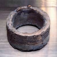 A weapons-grade ring of electrorefined plutonium, typical of the rings refined at Los Alamos and sent to Rocky Flats for fabrication. The ring has a purity of 99.96%, weighs 5.3 kg, and is approx 11 cm in diameter. It is enough plutonium for one bomb core. The ring shape helps with criticality safety (less concentrated material). | LOS ALAMOS NATIONAL LABORATORY [PUBLIC DOMAIN]