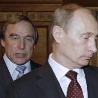 Russian President Vladimir Putin is seen with concert cellist Sergei Roldugin in 2009. A leak of documents from a Panamanian law firm puts Roldugin among those at the top of a multibillion-dollar offshore empire. | AFP-JIJI