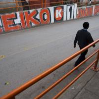 A man walks past a campaign mural promoting presidential candidate Keiko Fujimori in Tambo, Peru, on Saturday. Peru\'s general election took place on Sunday. | AP