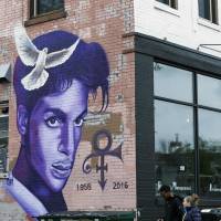 A mural honoring the late rock star Prince adorns a building in the Uptown area of Minneapolis Thursday, Prince died last week at his Paisley Park home at the age of 57. An investigation into his death continues. | AP