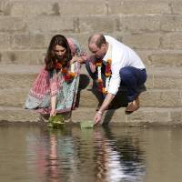 Britain’s Prince William and his wife, Catherine, Duchess of Cambridge, float flowers at the Banganga Water Tank in Mumbai, India, Sunday. Prince William, wife Kate pay respects to terrorist victims as royal tour of India starts