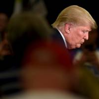 Republican U.S. presidential candidate Donald Trump leaves the stage after speaking at a town hall event in Appleton, Wisconsin, Wednesday. | REUTERS