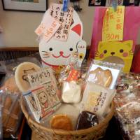 Cookies and Japanese confectionery shaped like maneki neko (beckoning cat) figures are sold at a shop on March 12 in Setagaya Ward, Tokyo. | YOSHIAKI MIURA