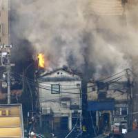 A building burns in Shinjuku\'s Kabukicho district on Tuesday. | KYODO