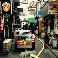 Due to the narrow width of alleys in Golden Gai, firefighters had to use trolleys to get water to source of the fire. | ANDREW LEE