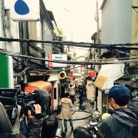 Media converge on the Golden Gai district not long after the fire started. | ANDREW LEE