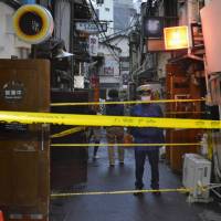 Police seal off the area Wednesday in the Golden Gai entertainment area in Tokyo\'s Shinjuku district that caught a fire the previous day. | KYODO