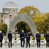 U.S. Secretary of State John Kerry puts his hand on Foreign Minister Fumio Kishida’s back after they and their fellow Group of Seven foreign ministers laid wreaths at the cenotaph at Hiroshima Peace Memorial Park on Monday. Also pictured (left to right) are EU High Representative for Foreign Affairs Federica Mogherini, Canadian Foreign Minister Stephane Dion, British Foreign Secretary Philip Hammond, German Foreign Minister Frank-Walter Steinmeier, Italian Foreign Minister Paolo Gentiloni and French Foreign Minister Jean-Marc Ayrault.  | POOL / AP