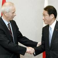 Visiting Canadian Foreign Minister Stéphane Dion shakes hands with his Japanese counterpart Fumio Kishida during bilateral talks Saturday evening in the city of Hiroshima ahead of the Group of Seven foreign ministers\' meeting that kicked off Sunday. | POOL/KYODO