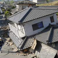 This house in the Kumamoto town of Mashiki came crashing down when a powerful earthquake struck the area in April 2016. | KYODO
