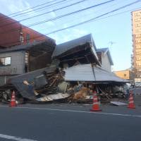 A collapsed house lies in Chuo Ward in the city of Kumamoto on Saturday.   | DAISUKE KIKUCHI