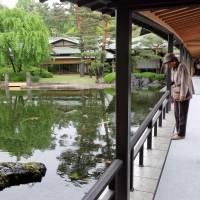 Visitors stroll a Japanese garden at the Kyoto State Guesthouse on the first of a 12-day public opening on Thursday. | KYODO