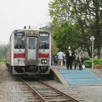 Rail fans are among visitors to Mashike Station in Hokkaido in May 2014, one of four stops on a stretch of line that is slated for closure this year. | KYODO