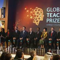 Japanese teacher Kazuya Takahashi (right) and fellow finalists for this year\'s Global Teacher Prize attend an awards ceremony during the Global Education and Skills Forum in Dubai on March 13. | MAGDALENA OSUMI